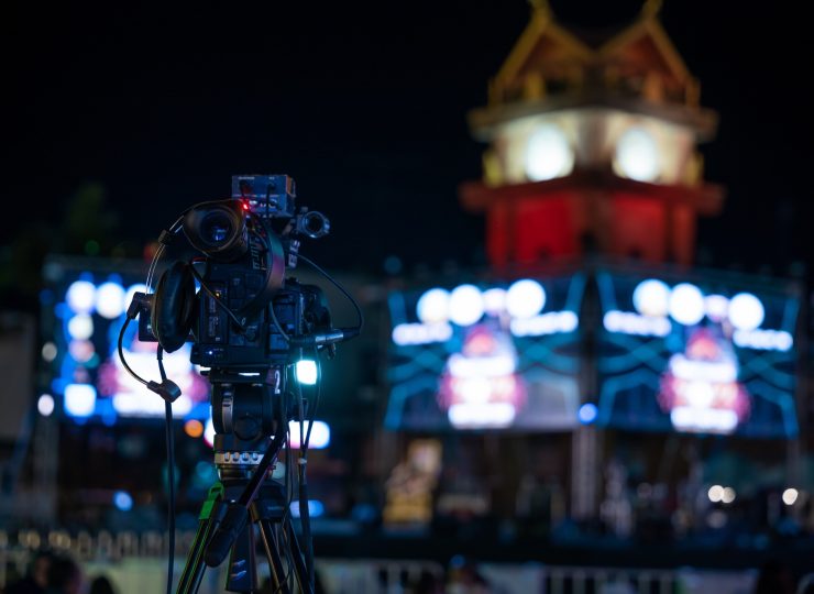 Professional video crew filming live event on stage. Expertise in movie production television